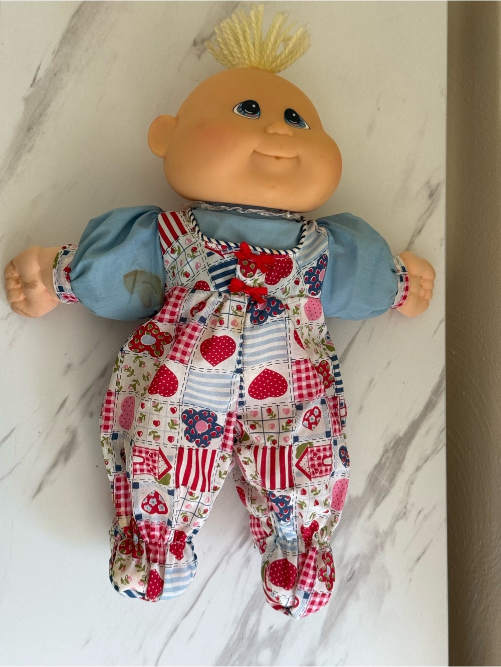 Plush Baby Doll in Blue Outfit with Multicolor Patchwork Overalls